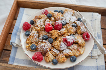Kaiserschmarrn - traditional austrian pancake dessert with fresh fruit