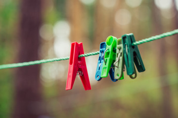 clothes pins hanging on a rope on a line
