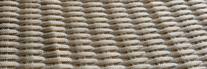 Woven panoramic light background. Simple abstract background of bright ropes