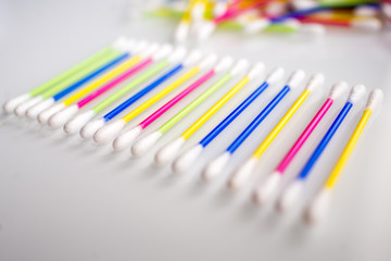  heap of colorful ear sticks on a white abstract background