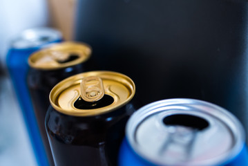  three beer cans on an abstract background