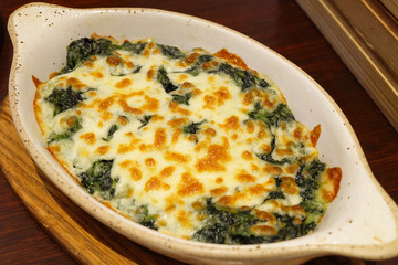 Baked Spinach with Cheese. Italian food.