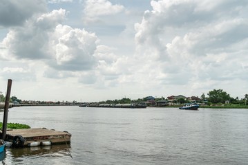 Fototapeta premium small blue boat on the river with sky and cloud.