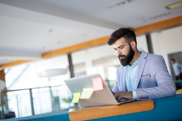 Young employee looking at computer monitor during working day