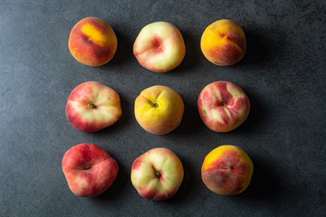 Close up of yammy fresh peaches on dark background surface. Nice summer fruit top view.