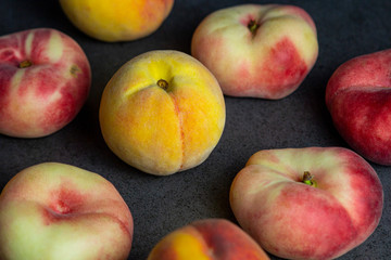 Close up of fresh summer peach on dark texture surface. Natural fruits.