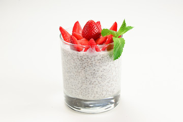 Chia pudding with strawberry and mint on a white background. Space for text or design.