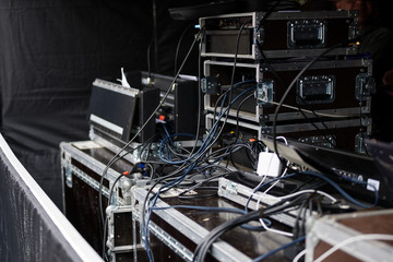 cases and racks from a sound amplification system for an event on an open-air stage
