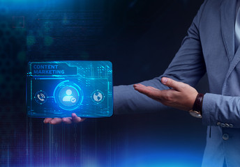 The concept of business, technology, the Internet and the network. A young entrepreneur working on a virtual screen of the future and sees the inscription: Content marketing