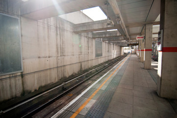 Fototapeta premium London Underground Station on a summer day. Without people. White and yellow stripe in the middle.