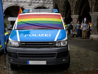 police car with a wet rainbow flag on the windshield at the rainy christopher street day 2019 in...