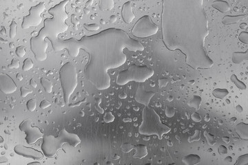 Water drops, rain on the surface of gray light metal, abstract background, close-up