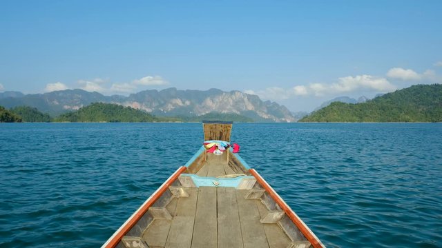 Wooden traditional longtail boat on Cheow Lan lake in Khao Sok National Park, Thailand