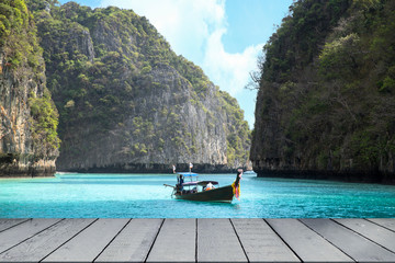 Maya Bay in Andaman sea and wooden boat with mountain view in phuket Thailand