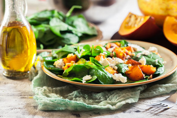 Roasted pumpkin salad with spinach and nuts