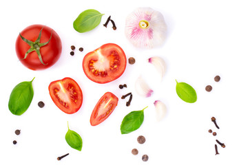 top view of whole and sliced ​​tomato with basil leaves and garlic, spice, isolated on white background