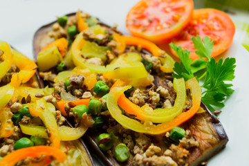 Fried eggplants with minced meat and different vegetables, flaxseed decoration, finished dish
