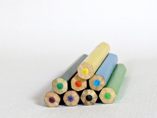 Stacked tip of colored colored pencils on white background. Closeup
