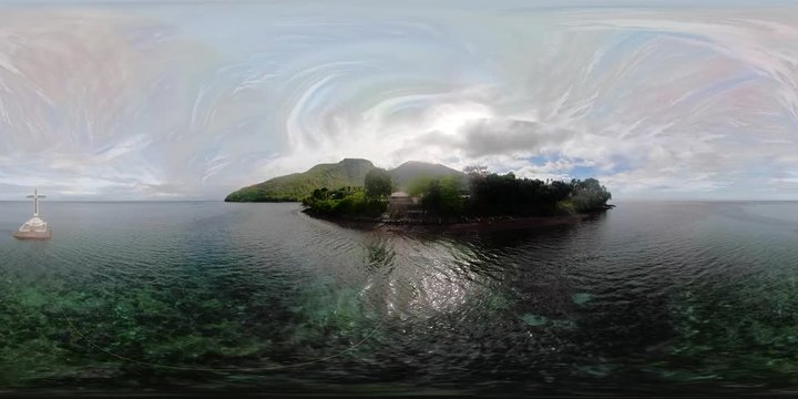 Catholic cross in sunken cemetery in the sea, 360VR aerial view. Sunset at Sunken Cemetery Camiguin Island Philippines.
