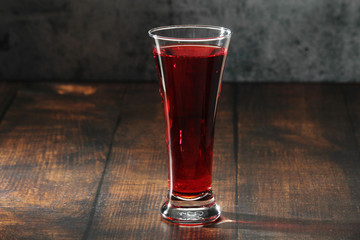 Red juicy drink in a high beer glass