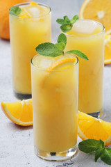 Glasses full of orange juice with ice