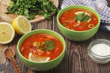 Two bowls with traditional Russian soup solyanka