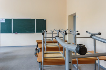 Empty classroom with inverted chairs on desks at the end of school lessons