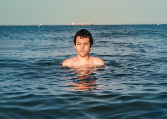 Young man relaxing and refreshing in the ocean