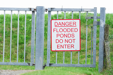 Flooded ponds water danger do not enter sign
