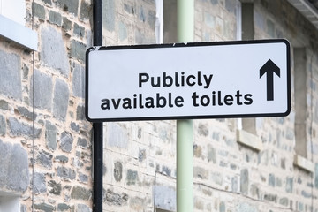 Publicly available toilets for the public sign