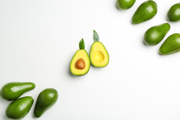 Fresh avocados on light background
