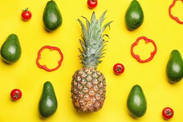 Fresh avocados, pepper, pineapple and tomato on color background