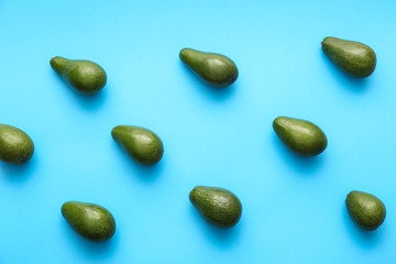 Fresh avocados on color background