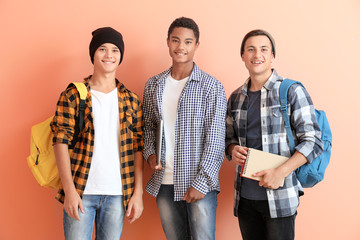 Portrait of young students on color background