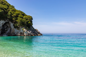 Fototapeta na wymiar Rovinia beach in Liapades. One of greek island Corfu natural beach view with crystal clear water. Corfu, Greece.