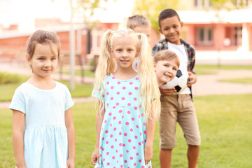 Cute little children with ball in park