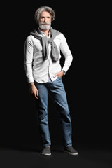Fototapeta premium Fashionable senior man on dark background