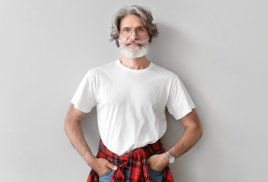 Fashionable Senior Man On Light Background