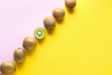 Whole kiwifruits and one half on color background. Concept of uniqueness