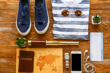 Set of items for travel on wooden background