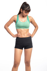 Fitness woman white background. Asian woman. Hands on hip, looking down, tired.