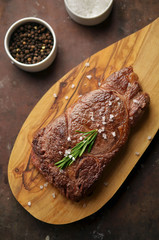 Juicy grilled steak on cutting board