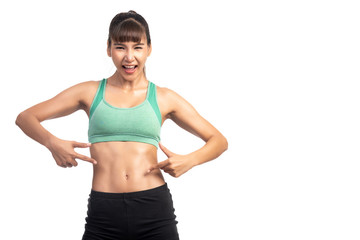 Fototapeta na wymiar Fitness woman white background. Asian woman. Focus on her six pack muscle, pointing finger.
