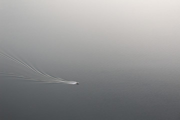 boat moving on grey sea water surface top view