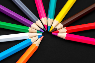 Fototapeta premium Colored pencils isolated on black background. Close up