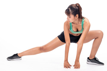 Fototapeta premium Fitness woman stretching isolated in white background. Asian girl in full body shot. Thigh muscle stretch, front shot.
