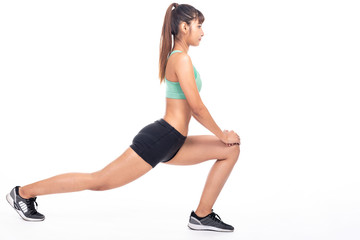 Fitness woman stretching isolated in white background. Asian girl in full body shot. Thigh muscle stretch, side shot.