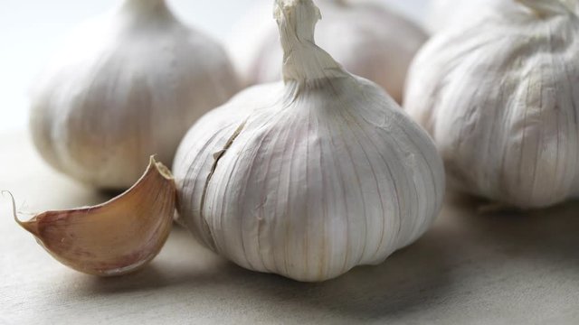 Whole garlic bulbs rotating in slow motion