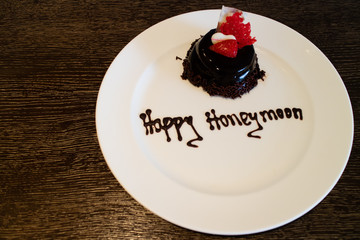 A honeymoon cake isolated on a wooden background