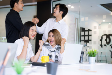 Diverse business people standing together happy and excited doing winner gesture with arms raised, smiling and screaming for success.